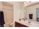 This well-lit bathroom features a vanity with a sink and a shower-tub combination at 5502 N Ormondo Way, Litchfield Park, AZ 85340