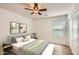 Cozy bedroom is brightly lit with natural light and features modern decor and neutral tones at 5502 N Ormondo Way, Litchfield Park, AZ 85340