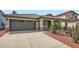 Exterior front view of home showing desert landscaping, tile roof and a two car garage at 5502 N Ormondo Way, Litchfield Park, AZ 85340