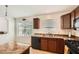 Efficient kitchen featuring wood cabinets, black appliances and granite countertops at 5502 N Ormondo Way, Litchfield Park, AZ 85340