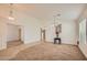 Spacious living room with neutral carpet, adjacent room access and natural lighting at 5502 N Ormondo Way, Litchfield Park, AZ 85340