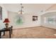 Open-concept living room features carpet flooring, windows and high ceilings at 5502 N Ormondo Way, Litchfield Park, AZ 85340