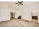 Spacious main bedroom with plush carpet, neutral walls, and access to the bathroom at 5502 N Ormondo Way, Litchfield Park, AZ 85340