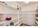 Walk-in pantry provides tons of storage space with ample shelving for organized convenience at 5502 N Ormondo Way, Litchfield Park, AZ 85340