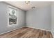 This bedroom features light gray walls, new wood flooring and a window for natural light at 5757 S 21St Ter, Phoenix, AZ 85040