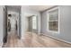 Bedroom featuring wood floors, a mirrored closet, and a bright window for natural light at 5757 S 21St Ter, Phoenix, AZ 85040