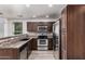 Well-equipped kitchen featuring stainless steel appliances, granite countertops, and dark wood cabinetry at 5757 S 21St Ter, Phoenix, AZ 85040
