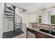 Kitchen area highlighting granite countertops, modern appliances, and a unique spiral staircase nearby at 5757 S 21St Ter, Phoenix, AZ 85040