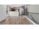 Open floor plan living room showcasing wood floors, modern lighting, and kitchen access at 5757 S 21St Ter, Phoenix, AZ 85040