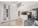 Bright living room with high ceilings, wood floors, and an open layout connecting to the kitchen at 5757 S 21St Ter, Phoenix, AZ 85040