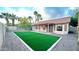 Backyard showcasing artificial turf, mature trees, a covered patio, and a desert landscape at 5941 W Venus Way, Chandler, AZ 85226