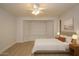 Bedroom showcasing neutral walls, wood-look flooring, a bed with end tables, bay window, and ceiling fan at 5941 W Venus Way, Chandler, AZ 85226
