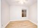 Empty bedroom boasts hardwood floors, a single window, and simple wall color at 5941 W Venus Way, Chandler, AZ 85226