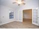 Bedroom featuring light walls, light woodgrain flooring and French doors to another room at 5941 W Venus Way, Chandler, AZ 85226