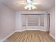 Bright, spacious bedroom with modern wood-look flooring, ceiling fan, a large bay window, and neutral walls at 5941 W Venus Way, Chandler, AZ 85226