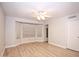 Bright, airy bedroom features neutral walls, wood-look flooring, a ceiling fan, and a charming bay window at 5941 W Venus Way, Chandler, AZ 85226