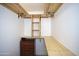 This walk-in closet boasts custom wood shelving, drawers, and ample storage space at 5941 W Venus Way, Chandler, AZ 85226