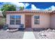 Inviting front of home with seating area, security door and well maintained desert landscape at 5941 W Venus Way, Chandler, AZ 85226