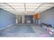 Well-organized two-car garage featuring built-in storage cabinets, workbench area, and plenty of space at 5941 W Venus Way, Chandler, AZ 85226