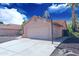 Attached two-car garage with concrete driveway and basketball hoop at 5941 W Venus Way, Chandler, AZ 85226