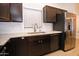 This kitchen features stainless steel appliances and a stylish backsplash and light countertops at 5941 W Venus Way, Chandler, AZ 85226