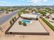 Aerial view of a desert property with a pool, brick fence and desert landscaping at 616 E Lavitt Ln, Phoenix, AZ 85086