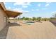 Spacious backyard featuring a covered patio, inviting pool and desert landscaping, perfect for outdoor living at 616 E Lavitt Ln, Phoenix, AZ 85086