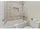 Bathroom features a tiled tub with a shower at 616 E Lavitt Ln, Phoenix, AZ 85086