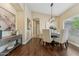 Elegant dining room with a modern chandelier, stylish furnishings, and ample space at 616 E Lavitt Ln, Phoenix, AZ 85086