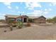 Inviting single-story home with desert landscaping and a stone exterior, creating a warm curb appeal at 616 E Lavitt Ln, Phoenix, AZ 85086
