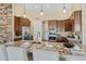 Spacious gourmet kitchen with marble counters, pendant lighting and stainless appliances at 616 E Lavitt Ln, Phoenix, AZ 85086