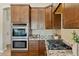 Gourmet kitchen featuring stainless oven, gas range and stone countertops with abundant cabinets at 616 E Lavitt Ln, Phoenix, AZ 85086