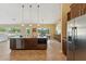 Open concept kitchen with stainless appliances, island, and easy access to the backyard pool at 616 E Lavitt Ln, Phoenix, AZ 85086