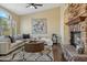 Inviting living room featuring a stone fireplace, comfortable seating, and stylish decor at 616 E Lavitt Ln, Phoenix, AZ 85086