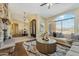 Cozy living room boasts a stone fireplace, natural light, and elegant furnishings at 616 E Lavitt Ln, Phoenix, AZ 85086