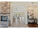 Open-concept view from foyer into the living room with stone fireplace and tile flooring at 616 E Lavitt Ln, Phoenix, AZ 85086