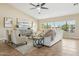 Bright living room with large windows, neutral décor, and tile floors at 616 E Lavitt Ln, Phoenix, AZ 85086