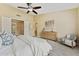 Bright main bedroom with ceiling fan, dresser, accent chair, and decor at 616 E Lavitt Ln, Phoenix, AZ 85086