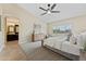 Main bedroom featuring vaulted ceiling, ceiling fan, dresser, and access to the en suite bath at 616 E Lavitt Ln, Phoenix, AZ 85086