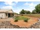 Landscaped backyard featuring a covered patio and low-maintenance desert landscaping at 662 S Saddle St, Gilbert, AZ 85233