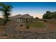 Charming home featuring a covered patio, landscaped yard, and mature trees at 662 S Saddle St, Gilbert, AZ 85233