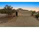 Dusk view of a charming single-story home with a well-maintained lawn, desert landscaping, and inviting curb appeal at 662 S Saddle St, Gilbert, AZ 85233
