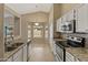 Kitchen with stainless appliances, granite counters and breakfast bar at 662 S Saddle St, Gilbert, AZ 85233