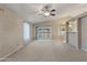 Bright living room with carpet flooring, access to back yard, and neutral color palette at 662 S Saddle St, Gilbert, AZ 85233