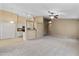 Open-concept living room with carpet flooring, a ceiling fan, and an adjacent breakfast bar at 662 S Saddle St, Gilbert, AZ 85233