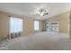 Spacious living room with carpet floors, neutral walls, and sliding door access to the backyard at 662 S Saddle St, Gilbert, AZ 85233