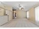 Bright living room featuring a ceiling fan and neutral carpet at 662 S Saddle St, Gilbert, AZ 85233