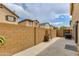Backyard featuring a concrete patio surrounded by a block wall and neighboring houses at 6907 S 8Th Dr, Phoenix, AZ 85041