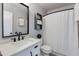 Bathroom featuring a vanity with a white countertop and black fixtures next to a white shower curtain at 6907 S 8Th Dr, Phoenix, AZ 85041