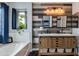 Bathroom featuring a white soaking tub, a wood-look vanity, and decorative wood planked walls at 6907 S 8Th Dr, Phoenix, AZ 85041